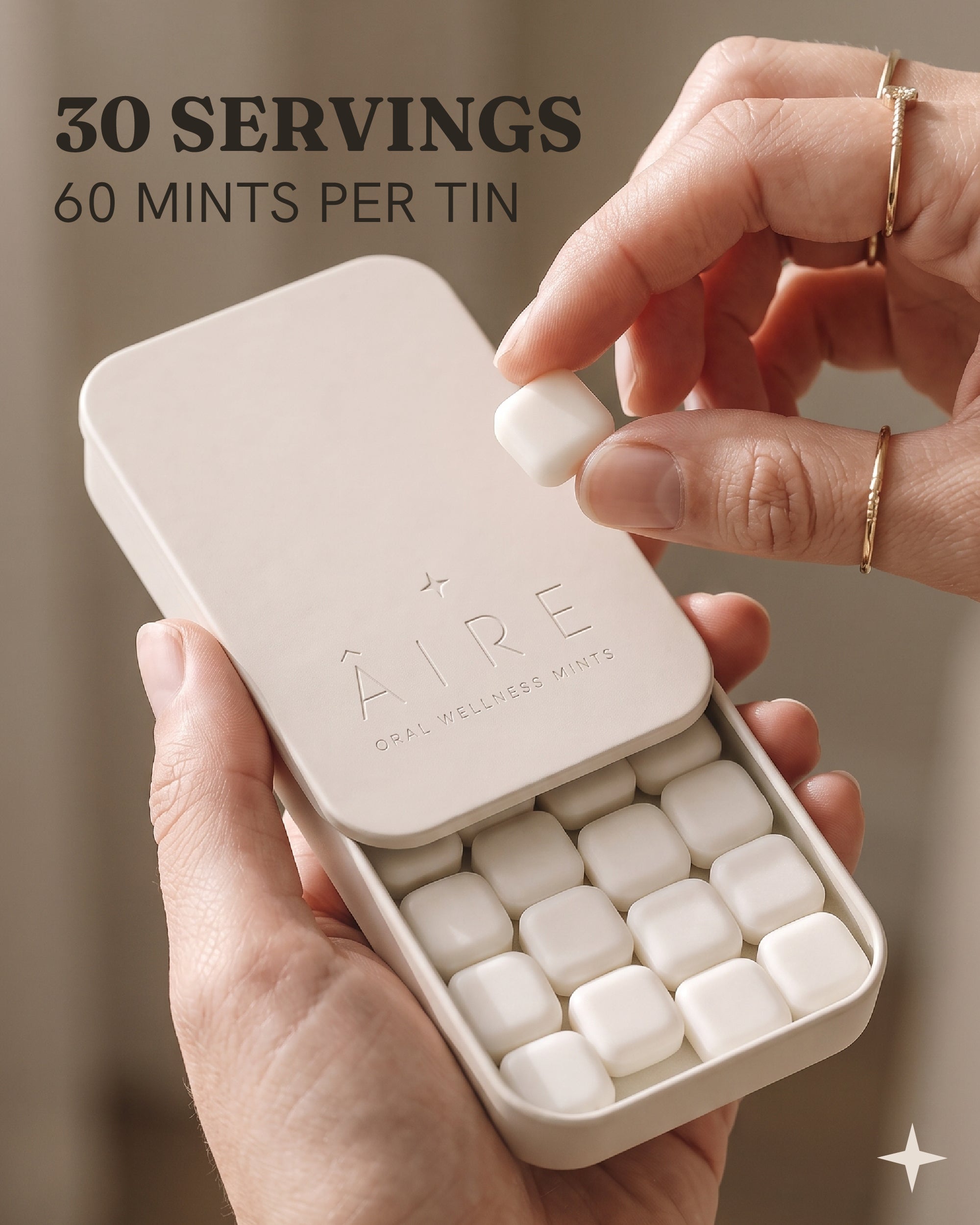 Hand taking an Âire mint from the open slide tin, 60 mints, 30 servings per tin